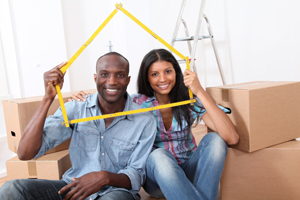 Young couple sitting next to moving boxes